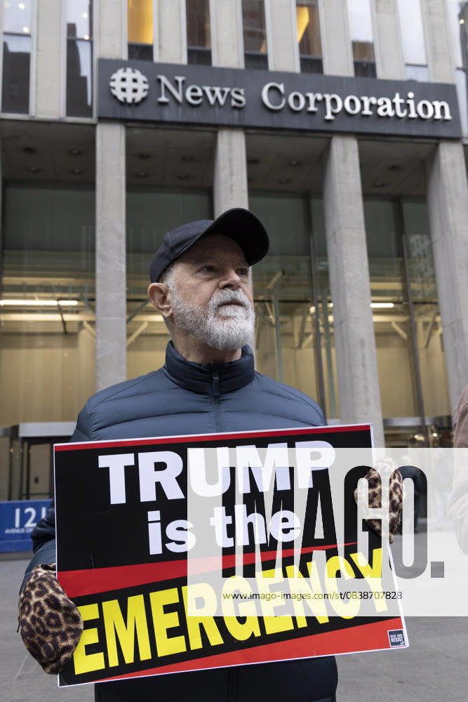 A demonstrator holds a sign that reads TRUMP is the EMERGENCY joining peaceful protesters outside of News Corp s Fox News Channel in midtown Manhattan. People with the activist groups Rise & Resist and Truth Tuesdays call for truth in journalism and denounce ICE, Federal troops sent to cities and Fox News as extremist right-wing propaganda in support of President Trump s administration. New York USA - ZUMAr174 20251028_znp_r174_028