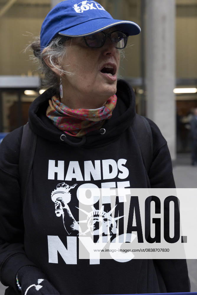 A demonstrator wears a sweatshirt that reads HANDS OFF NYC with an image of the Statue of Liberty joining peaceful protesters chanting and holding signs outside of News Corp s Fox News Channel in midtown Manhattan. People with the activist groups Rise & Resist and Truth Tuesdays call for truth in journalism and denounce ICE, Federal troops sent to cities and Fox News as extremist right-wing propaganda in support of President Trump s administration. New York USA - ZUMAr174 20251028_znp_r174_030
