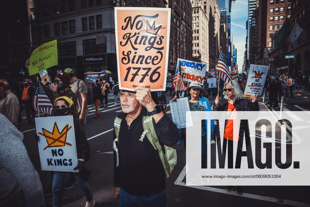 A demonstrator holds a sign while marching during the second No Kings protest in Manhattan. An estimated 350,000 attended this event. New York USA - ZUMAp287 20251018_znp_p287_004