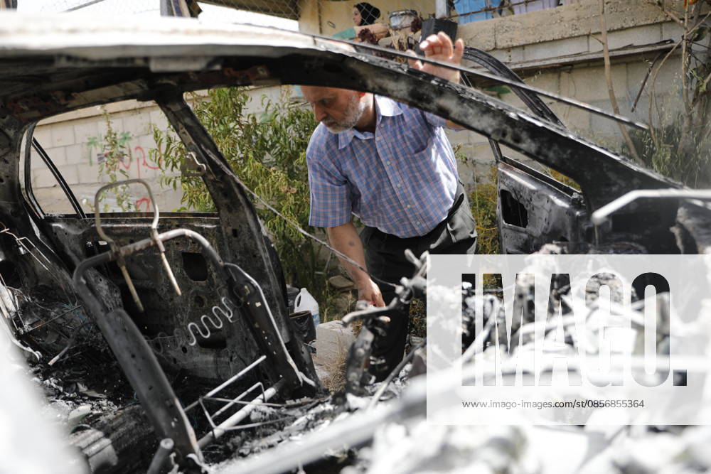 Palestinians inspect damage after settler attack near Hebron Palestinians inspect damage at the site of an attack carried out by Israeli settlers targeting Palestinian vehicles and property in the town of Surif northwest of Hebron in the occupied West Bank on May 17, 2026. Settlers set fire to a vehicle and spray-painted racist slogans at the scene, amid anger and condemnation among Palestinian residents over repeated attacks on their property. Photo by Mamoun Wazwaz apaimages Hebron West Bank Palestinian Territory 170526_Hebron_MW_00(5)