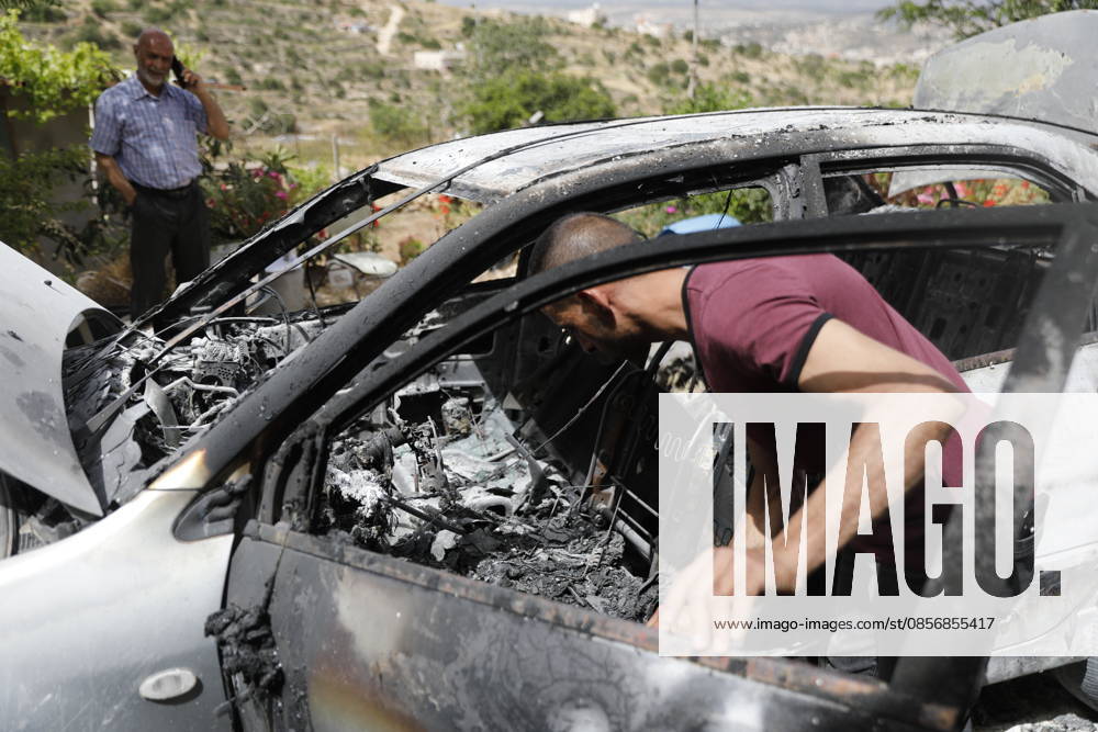 Palestinians inspect damage after settler attack near Hebron Palestinians inspect damage at the site of an attack carried out by Israeli settlers targeting Palestinian vehicles and property in the town of Surif northwest of Hebron in the occupied West Bank on May 17, 2026. Settlers set fire to a vehicle and spray-painted racist slogans at the scene, amid anger and condemnation among Palestinian residents over repeated attacks on their property. Photo by Mamoun Wazwaz apaimages Hebron West Bank Palestinian Territory 170526_Hebron_MW_00(2)