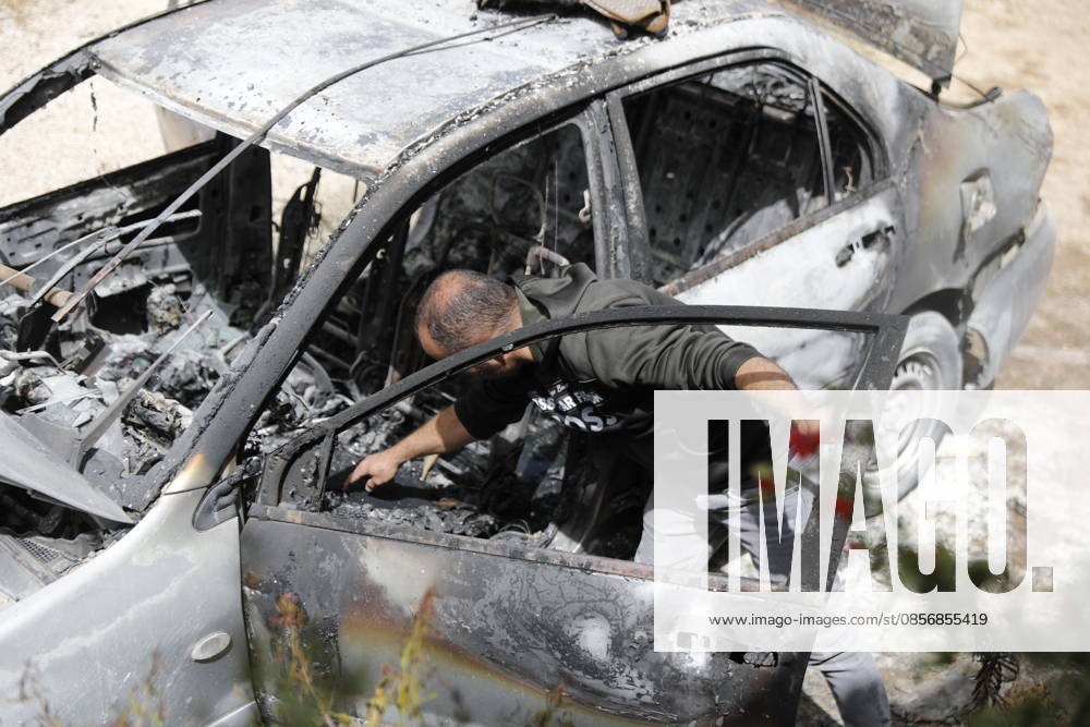 Palestinians inspect damage after settler attack near Hebron Palestinians inspect damage at the site of an attack carried out by Israeli settlers targeting Palestinian vehicles and property in the town of Surif northwest of Hebron in the occupied West Bank on May 17, 2026. Settlers set fire to a vehicle and spray-painted racist slogans at the scene, amid anger and condemnation among Palestinian residents over repeated attacks on their property. Photo by Mamoun Wazwaz apaimages Hebron West Bank Palestinian Territory 170526_Hebron_MW_00(21)