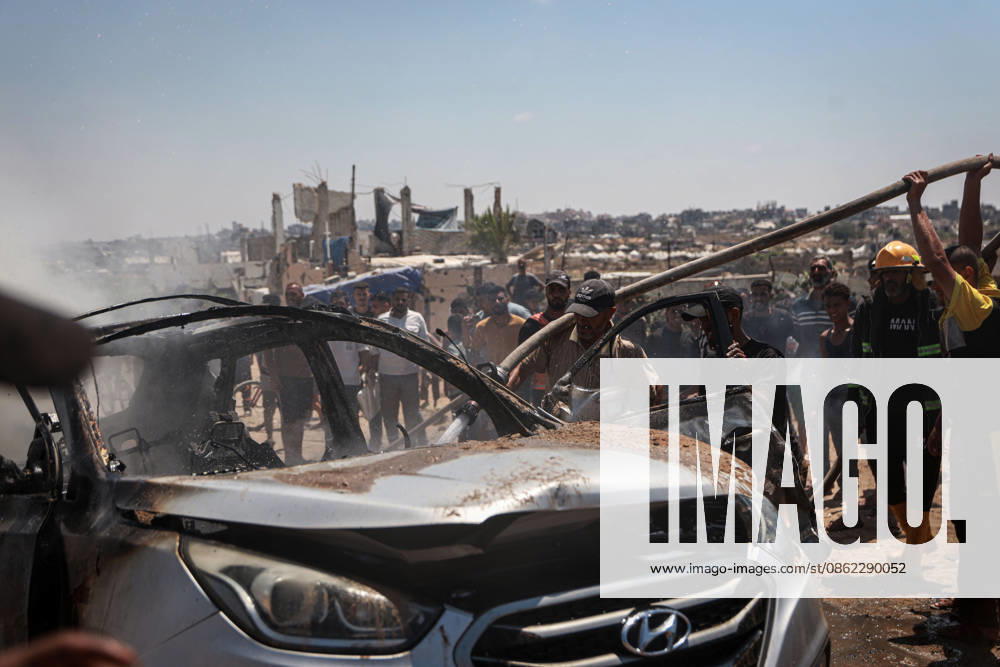 Israeli attacks continue in Gaza GAZA, PALESTINE - JULY 21 : Firefighters and local Palestinians attempt to extinguish a burning civilian vehicle after it was targeted in an Israeli attack in the Nuseirat refugee camp in the central Gaza Strip on July 21, 2026 in Gaza, Palestine. Abdalhkem Abu Riash Anadolu Gaza City Gaza. Editorial use only. Please get in touch for any other usage.