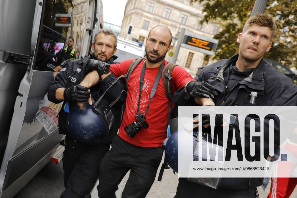 BERLIN, GERMANY, OCTOBER 3, 2026: Thousands of people march through central Berlin during a peace demonstration against military rearmament, compulsory military service and war on German Unity Day. Protesters gathered near the Brandenburg Gate before marching through the city, with trade unions, peace movements, political groups and a pro-Palestinian bloc taking part. Berlin police estimated attendance at around 5,800, while organizers put the number at more than 20,000. Police detained at least two protesters during the demonstration. Berlin Germany - ZUMAq101 20261003_zna_q101_191
