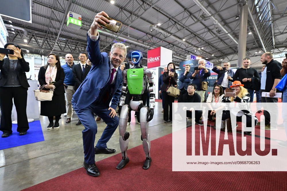 Czech Senate President Milos Vystrcil takes a selfie with a humanoid robot at opening of the 67th International Engineering Fair, which begins at Vystaviste 1 exhibition grounds in Brno, Czech Republic, on October 6th, 2026. International Fair of Machine Tools and Forming Machines IMT, International Welding Engineering Fair Welding, International Fair of Plastics, Rubber and Composites Plastex, International Fair of Surface Treatment Technologies Profintech and International Foundry Fair Fond-Ex also start. (CTKxPhoto VaclavxSalek) CTKPhotoP2026100603482 CTKPhotoP2026100603482