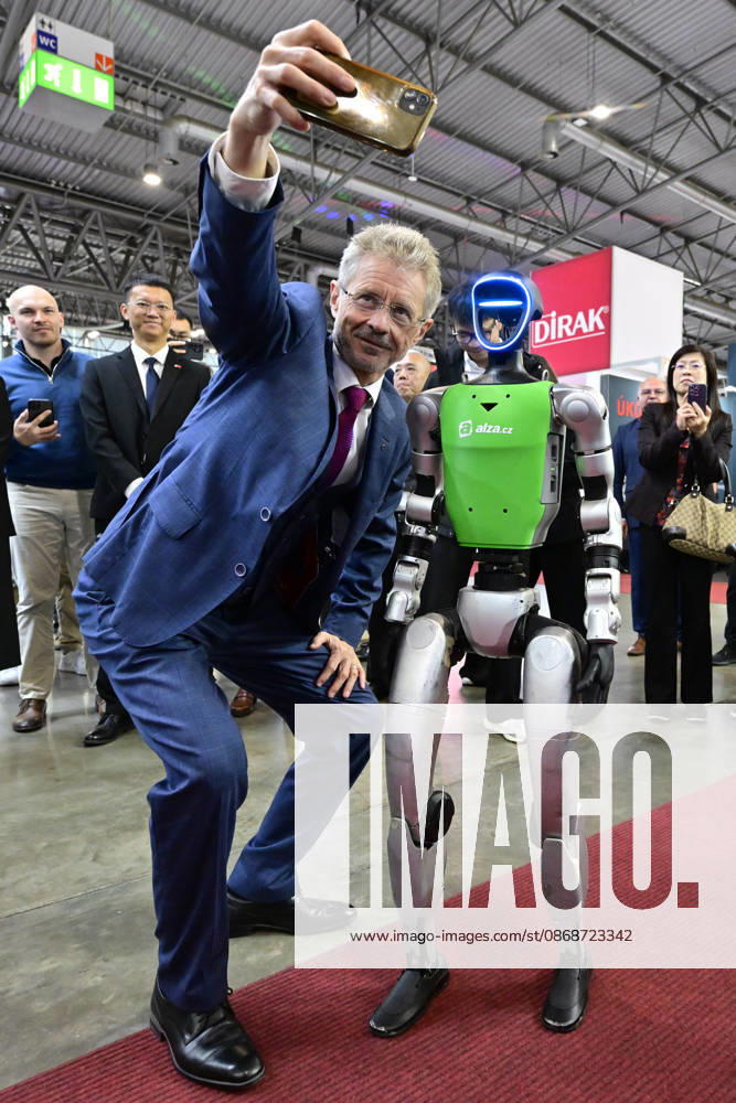 Czech Senate President Milos Vystrcil takes a selfie with a humanoid robot at opening of the 67th International Engineering Fair, which begins at Vystaviste 1 exhibition grounds in Brno, Czech Republic, on October 6th, 2026. International Fair of Machine Tools and Forming Machines IMT, International Welding Engineering Fair Welding, International Fair of Plastics, Rubber and Composites Plastex, International Fair of Surface Treatment Technologies Profintech and International Foundry Fair Fond-Ex also start. (CTKxPhoto VaclavxSalek) CTKPhotoP2026100605272 CTKPhotoP2026100605272