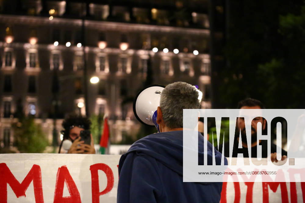 A protester speaks through a megaphone in front of a banner opposing the visit of US Secretary of State MARCO RUBIO during an anti-war demonstration. Athens GREECE - ZUMAx103 20261006_zip_x103_009