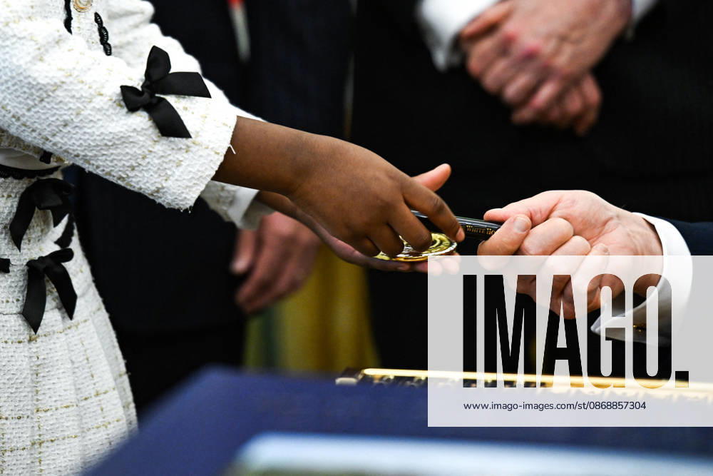 Trump Makes Oval Office Announcement WASHINGTON, DC - OCT. 7: US President Donald Trump hands a challenge coin and a pen to a child during an announcement on Trump Accounts in the Oval Office on Wednesday, Oct. 7, 2026 at the White House in Washington, D.C. (Photo by Annabelle Gordon Pool For The Washington Post) Washington DC United States