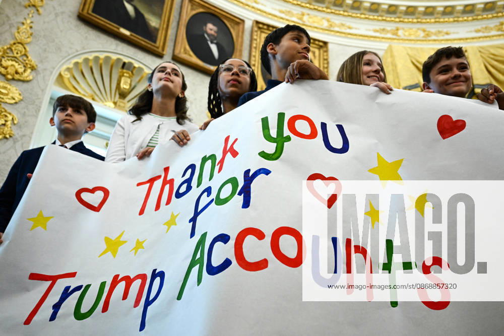Trump Makes Oval Office Announcement WASHINGTON, DC - OCT. 7: Kids hold up a sign as US President Donald Trump speaks during an announcement on Trump Accounts in the Oval Office on Wednesday, Oct. 7, 2026 at the White House in Washington, D.C. (Photo by Annabelle Gordon Pool For The Washington Post) Washington DC United States
