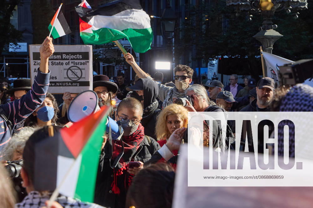 A protester raises a megaphone as demonstrators hold flags and signs during a pro-Palestinian rally at City Hall Park in New York City, New York. New York USA - ZUMAs237 20261007_aap_s237_005