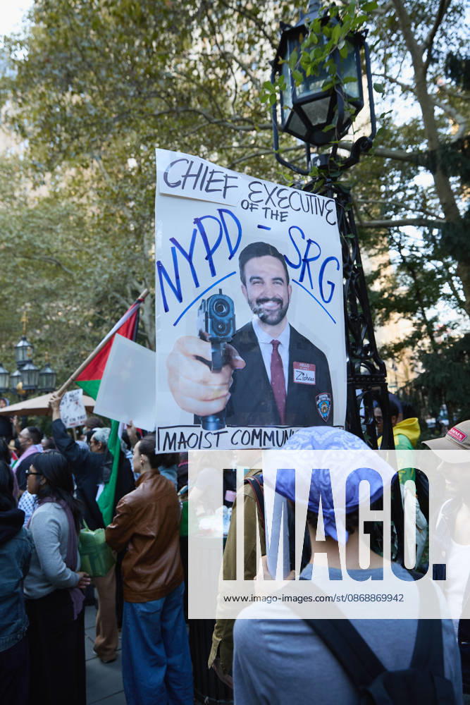 A demonstrator wearing a keffiyeh holds a poster during a pro-Palestinian protest at City Hall Park in New York City, New York. New York USA - ZUMAs237 20261007_aap_s237_020