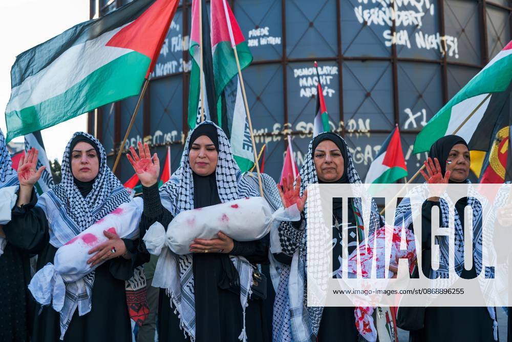 BERLIN, GERMANY, OCTOBER 7, 2026: Demonstrators gather at Checkpoint Charlie in central Berlin to mark three years since the start of the Gaza war. Participants protest against Israelâ€⠢s military actions in Gaza, which they describe as genocide, and express solidarity with Palestinians. Berlin Germany - ZUMAq101 20261007_zna_q101_413