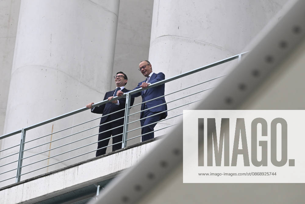 British Prime Minister Burnham welcomed with military ceremony in Berlin BERLIN, GERMANY - OCTOBER 8: German Chancellor Friedrich Merz (R) and British Prime Minister Andy Burnham (L) chat on the balcony of the Federal Chancellery following a military welcoming ceremony held for Burnham in Berlin, Germany, on October 8, 2026. Halil Sagirkaya Anadolu Berlin Germany. Editorial use only. Please get in touch for any other usage.