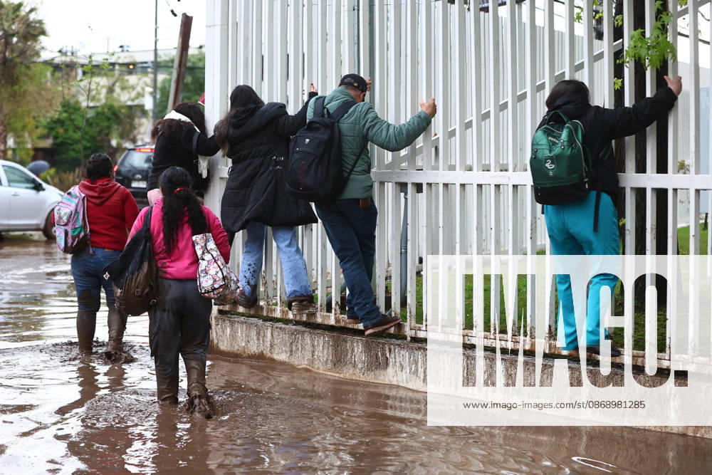 A mudslide is affecting the area from San Carlos de Apoquindo to Los Dominicos in the Las Condes district, causing widespread damage and sweeping away vehicles and people. Javier Salvo Aton, Chile, Aton 1197952
