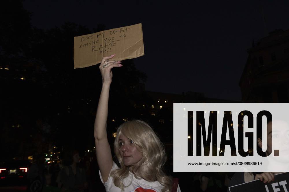 A demonstrator holds a sign that reads Does my outfit entitle you to RAPE me? joining hundreds at a rally in Foley Square outside the New York State Supreme Court building in Lower Manhattan under the banner . StopSexualViolence: From the Frat House to the White House. The protest is one of many rallies and campus walkouts around the country demanding justice for Cornell s Jane Doe. New York USA - ZUMAr174 20261008_znp_r174_010