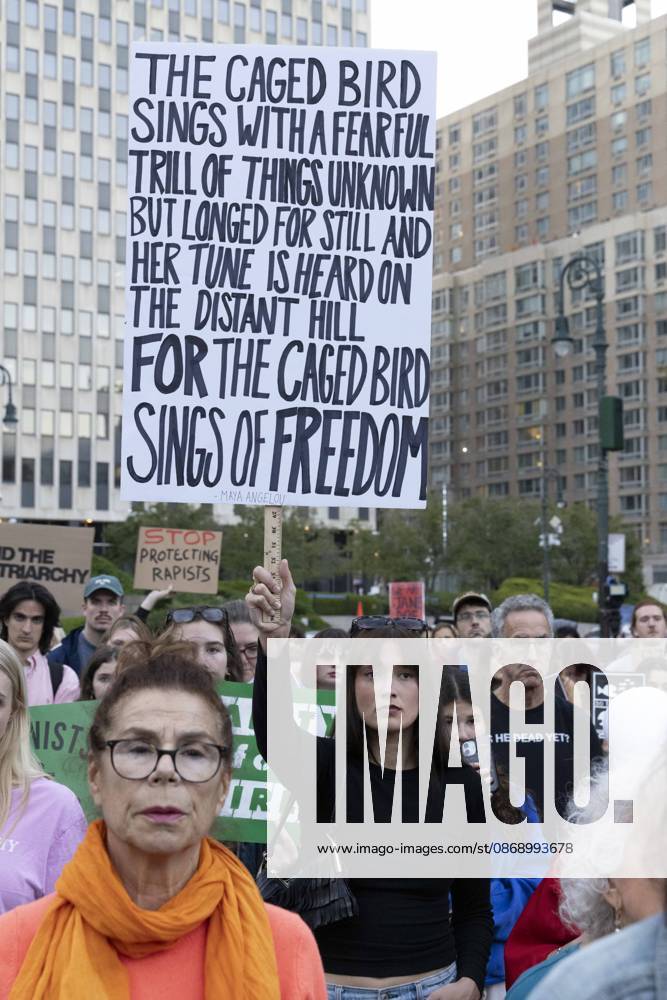 A demonstrator holds a sign that reads THE CAGED BIRD SINGS WITH A FEARFUL TRILL OF THINGS UNKNOWN BUT LONGED FOR STILL AND HER TUNE IS HEARD ON THE DISTANT HILL FOR THE CAGED BIRD SINGS OF FREEDOM joining hundreds at a rally in Foley Square outside the New York State Supreme Court building in Lower Manhattan under the banner . StopSexualViolence: From the Frat House to the White House. The protest is one of many rallies and campus walkouts around the country demanding justice for Cornell s Jane Doe. New York USA - ZUMAr174 20261008_znp_r174_036