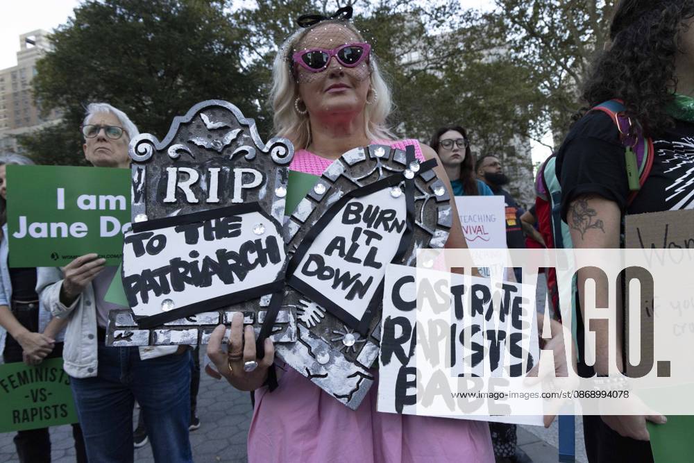 A demonstrator holds signs that read RIP TO THE PATRIARCH BURN IT ALL DOWN CASTRATE RAPISTS BABE joining hundreds at a rally in Foley Square outside the New York State Supreme Court building in Lower Manhattan under the banner . StopSexualViolence: From the Frat House to the White House. The protest is one of many rallies and campus walkouts around the country demanding justice for Cornell s Jane Doe. New York USA - ZUMAr174 20261008_znp_r174_022