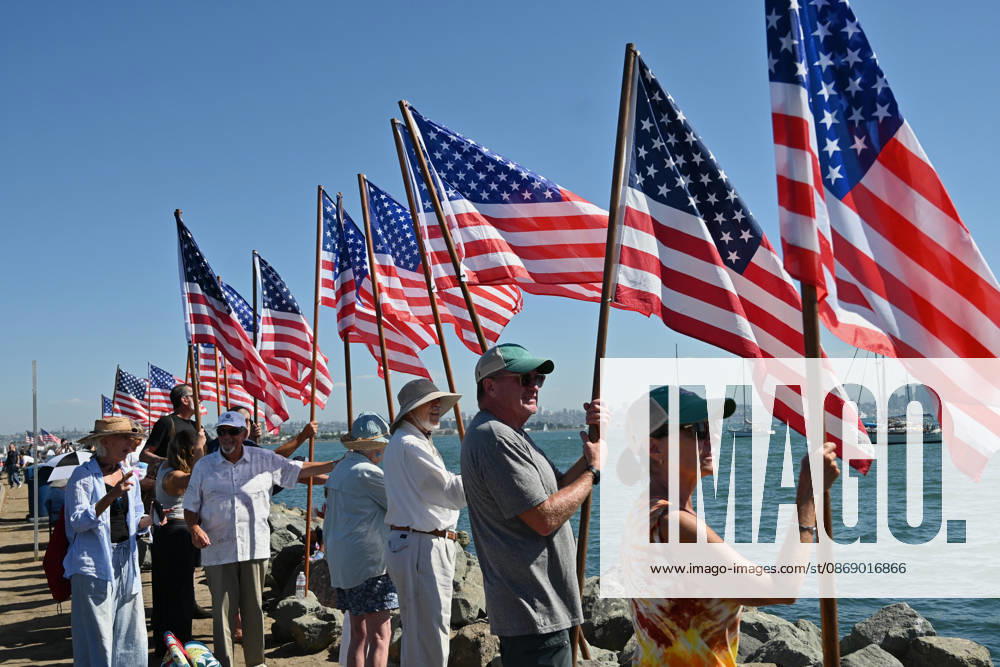 USS Abraham Lincoln returns to home port of San Diego after near-record deployment SAN DIEGO, UNITED STATES - OCTOBER 08: People raise flags as the USS Abraham Lincoln Nimitz-class aircraft carrier approaches its homeport at Naval Air Station North Island on return from its historic 10-month deployment on October 8, 2026 as seen from the Port of San Diego in San Diego, California, United States. The USS Abraham Lincoln (CVN 72) set a U.S. Navy record spending over 260 days consecutively at sea without a port call while playing a key role in Operation Epic Fury and regional maritime security operations in the Middle East. Carlos A. Moreno Anadolu San Diego United States. Editorial use only. Please get in touch for any other usage.