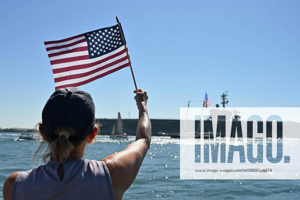 USS Abraham Lincoln returns to home port of San Diego after near-record deployment SAN DIEGO, UNITED STATES - OCTOBER 08: People raise flags as the USS Abraham Lincoln Nimitz-class aircraft carrier approaches its homeport at Naval Air Station North Island on return from its historic 10-month deployment on October 8, 2026 as seen from the Port of San Diego in San Diego, California, United States. The USS Abraham Lincoln (CVN 72) set a U.S. Navy record spending over 260 days consecutively at sea without a port call while playing a key role in Operation Epic Fury and regional maritime security operations in the Middle East. Carlos A. Moreno Anadolu San Diego United States. Editorial use only. Please get in touch for any other usage.