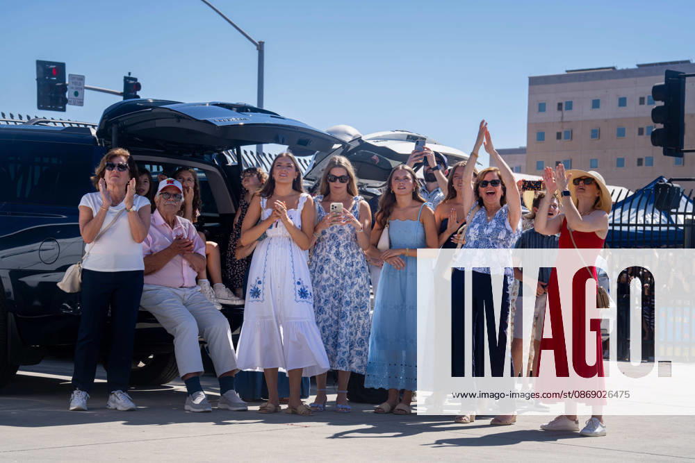 Family members and supporters applaud and wave as the aircraft carrier USS Abraham Lincoln (CVN 72) returns to Naval Air Station North Island in Coronado, California, on October 8, 2026, following a deployment. Some in the crowd record the homecoming on their phones as they wait near the waterfront. Coronado United States - ZUMAg374 20261008_znp_g374_004