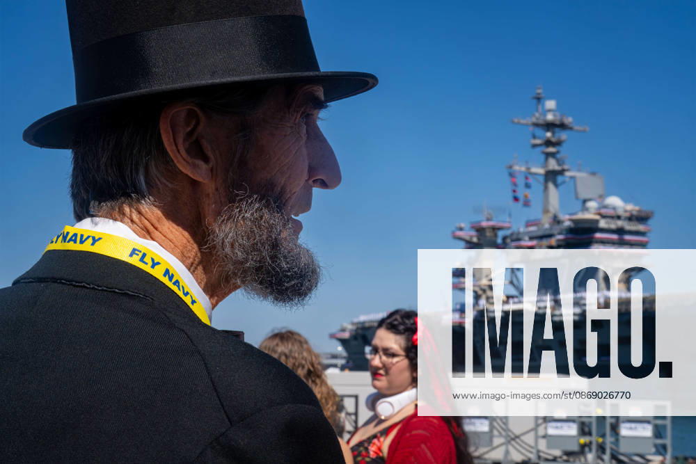 Robert Broski, a presenter who portrays Abraham Lincoln, watches the aircraft carrier USS Abraham Lincoln (CVN 72) during its homecoming at Naval Air Station North Island in Coronado, California, on October 8, 2026. Coronado United States - ZUMAg374 20261008_znp_g374_009