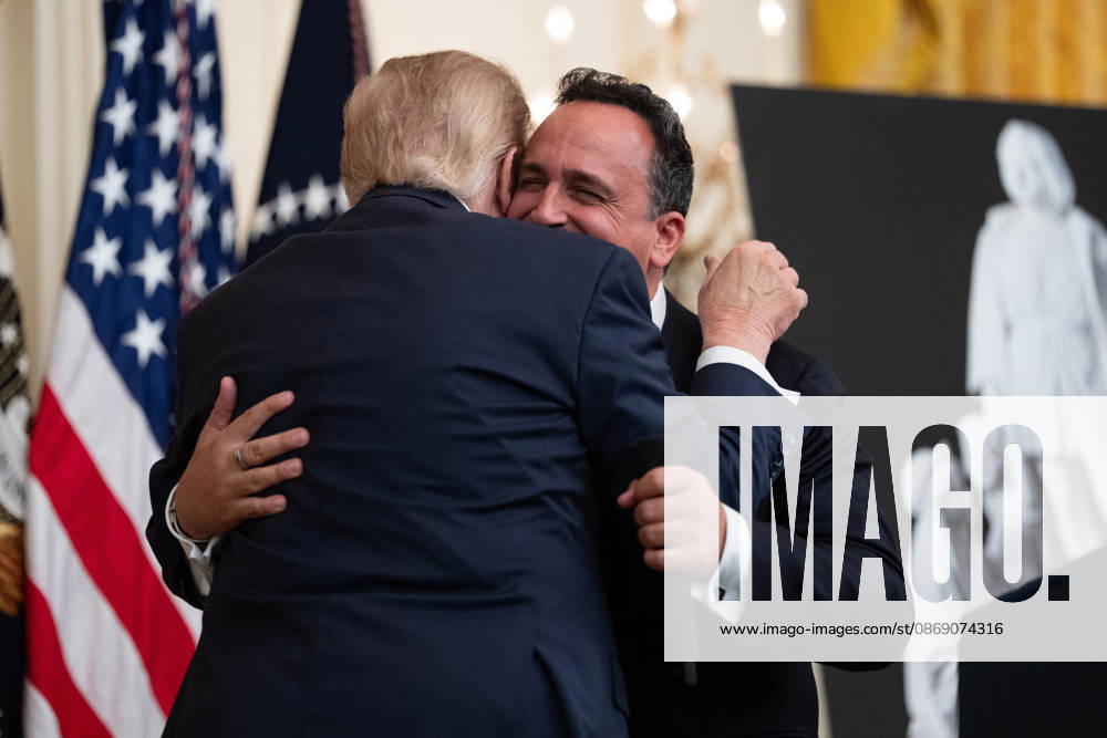 US President Donald Trump Gives Remarks - Washington DC US President Donald Trump embraces singer Christopher Macchio during an event in the East Room of the White House in Washington, DC, US, on Friday, Oct. 9, 2026. Trump is hosting a Columbus Day celebration. Photo by Aaron Schwartz Pool ABACAPRESS.COM Washington District of Columbia