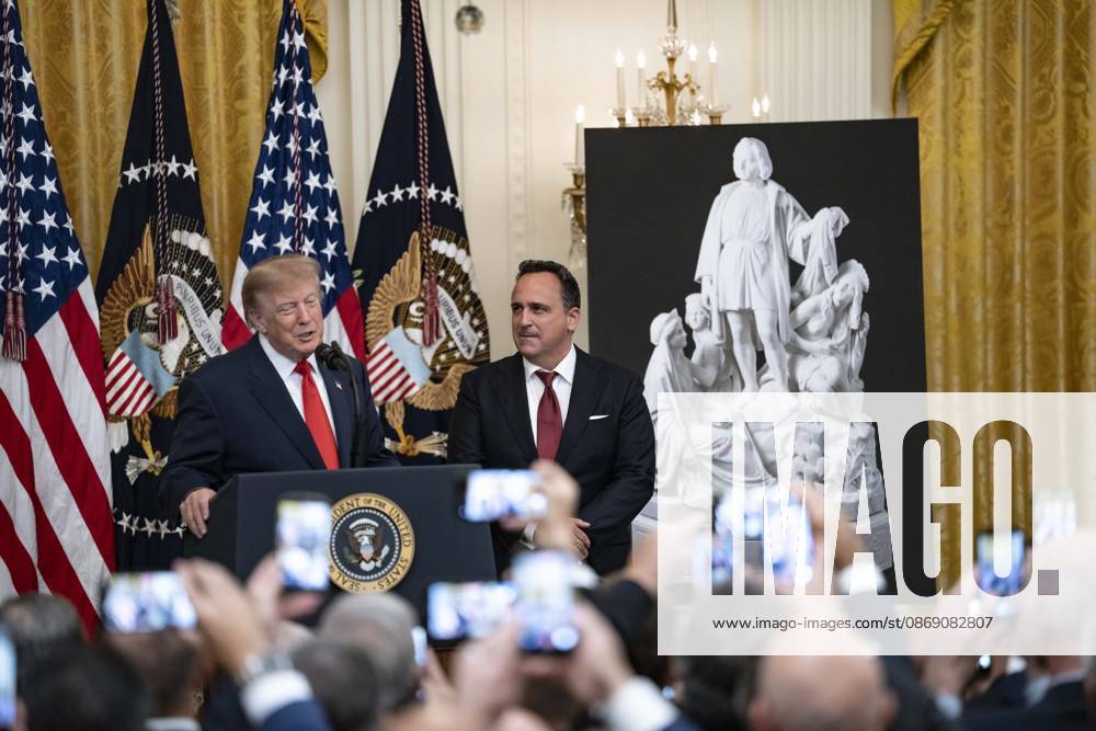 United States President Donald J Trump makes remarks as singer Christopher Macchio looks on during a Columbus Day Celebration in the East Room of the White House in Washington, DC, USA on Friday