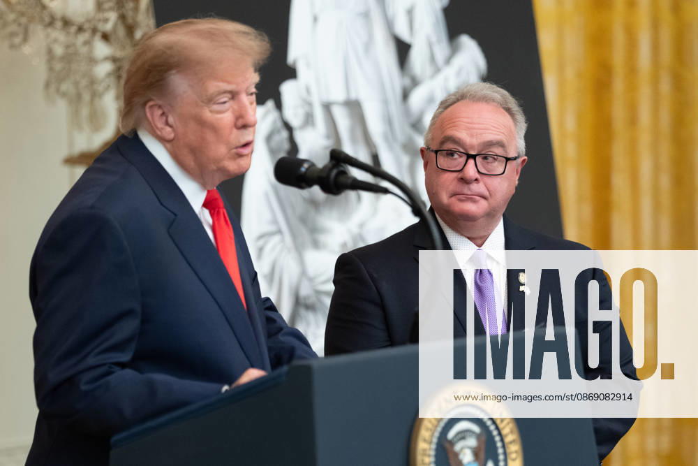 Brett Rugo, founder of Rugo Stone which constructed a helipad on the South Lawn, looks on as United States President Donald J Trump makes remarks during a Columbus Day Celebration in the East Room of the White House in Washington, DC, USA on Friday