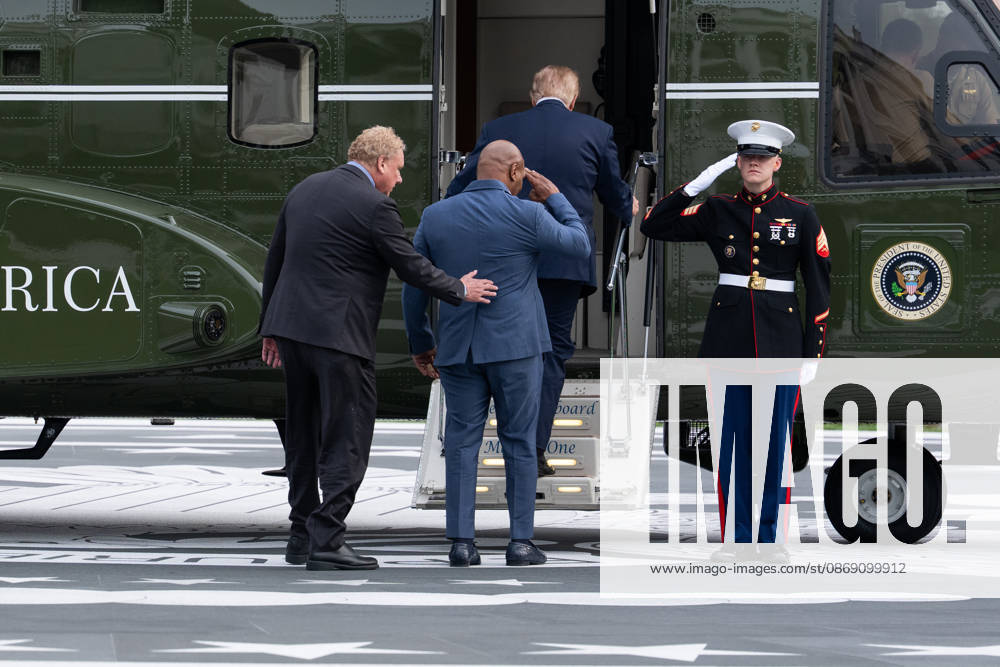 President Donald Trump and president of the New York yankees Randy Levine board Marine One as former professional boxer Mike Tyson salutes a marine in Washington, DC on Friday, Oct. 9, 2026. Trump is heading to Syracuse on Friday to boost Republican gubernatorial candidate Bruce Blakeman, who is trailing Governor Kathy Hochul in polls ahead of November s election. WASP20261009157 AaronxSchwartz