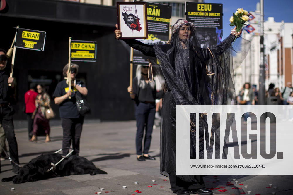 Protest in Madrid on the Day Against the Death Penalty - 10 Oct 2026 A woman holds a portrait, wearing a veil on her head during a rally against the death penalty in Callao Square in central Madrid. World Day Against the Death Penalty has been observed every October 10th since 2003. Madrid Spain