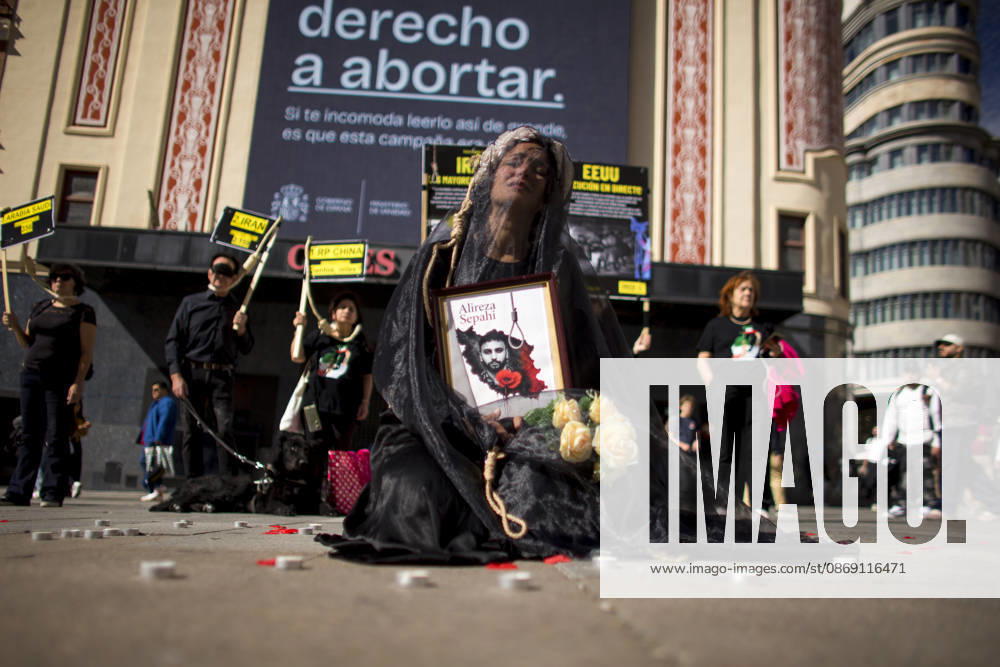 Protest in Madrid on the Day Against the Death Penalty - 10 Oct 2026 A woman holds a portrait, wearing a veil on her head during a rally against the death penalty in Callao Square in central Madrid. World Day Against the Death Penalty has been observed every October 10th since 2003. Madrid Spain