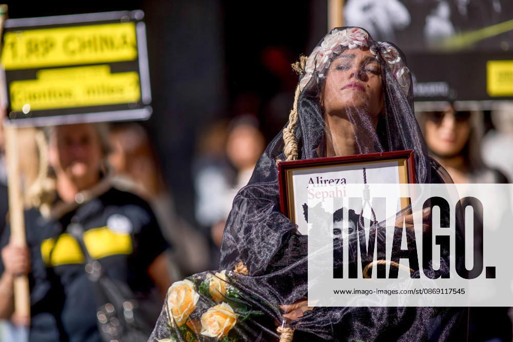 A woman holds a portrait, wearing a veil on her head during a rally against the death penalty in Callao Square in central Madrid. World Day Against the Death Penalty has been observed every October 10th since 2003. Madrid Spain - ZUMAs197 20261010_aaa_s197_022