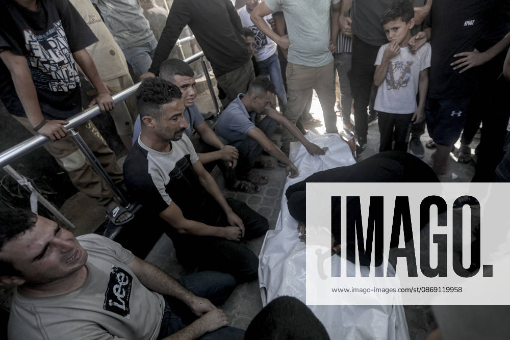 Gaza Palestine Airstrike Aftermath Mourners weep around a shrouded body outside Al-Shifa Hospital in Gaza City, Palestine on October 10, 2026. Four Palestinians were killed in an air strike near Panda Mall, and people carried the victims toward Al-Shifa Hospital for funeral prayers. Gaza Gaza Strip Palestinian Territories