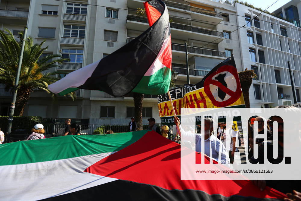 Protesters carry a large Palestinian flag and an anti-war banner during a march in solidarity with Palestine. Athens GREECE - ZUMAx103 20261010_zip_x103_009
