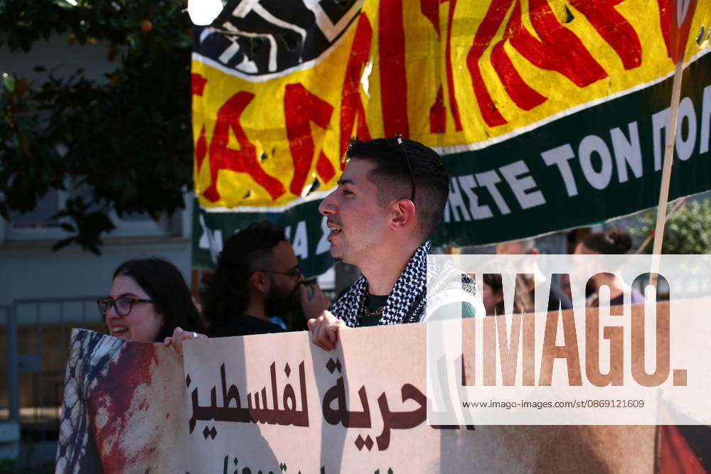 A demonstrator wearing a Palestinian keffiyeh marches behind a banner calling for freedom for Palestine. Athens GREECE - ZUMAx103 20261010_zip_x103_015