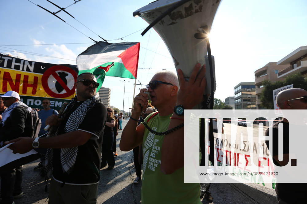 A protester speaks into a megaphone as Palestinian flags and anti-war banners are displayed behind him. Athens GREECE - ZUMAx103 20261010_zip_x103_027
