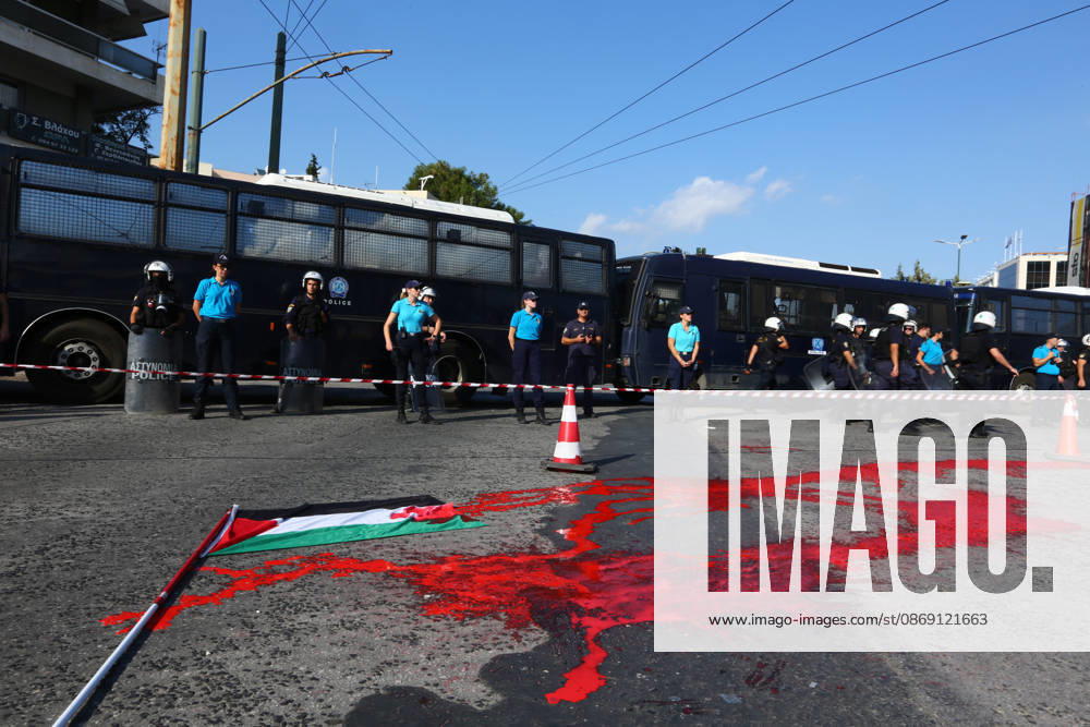 Police officers stand behind a cordon near police buses, as red paint and a Palestinian flag lie on the road during a pro-Palestinian demonstration. Athens GREECE - ZUMAx103 20261010_zip_x103_026