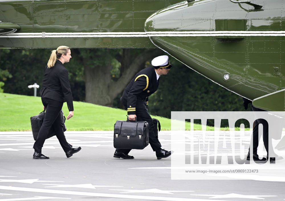 DC: Trump Departs for Clarksville, TN Aides carrying the briefcases referred to as the football board Marine One to accompany United States President Donald J Trump as he departs the South Lawn of the White House in Washington, DC, USA, en route Clarksville, Tennessee on Saturday, October 10, 2026. The President will participate in a campaign rally for Tennessee Republican candidates on the ballot in November. Credit: Ron Sachs Pool via CNP Washington District of Columbia United States