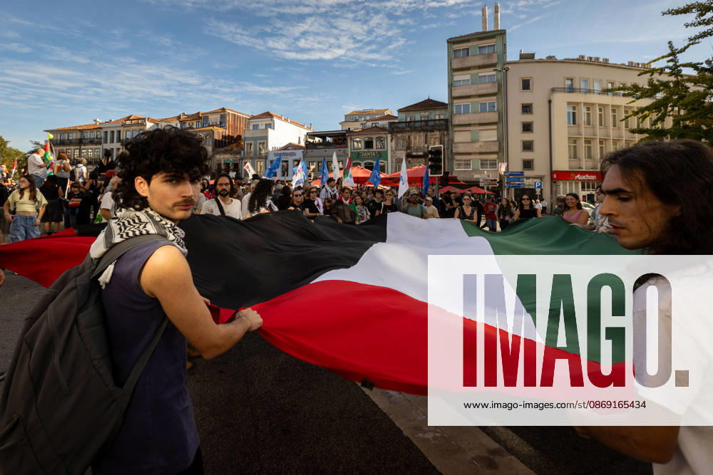 Palestine Solidarity March in Porto - 10 Oct 2026 Participants carry a large Palestinian flag at the start of a Palestine solidarity march. Hundreds of demonstrators gathered in Porto for a Palestine solidarity march calling for an end to the war in Gaza and support for Palestinian rights. The march began at Praça dos Poveiros and concluded at Praça D. João I. Porto Portugal