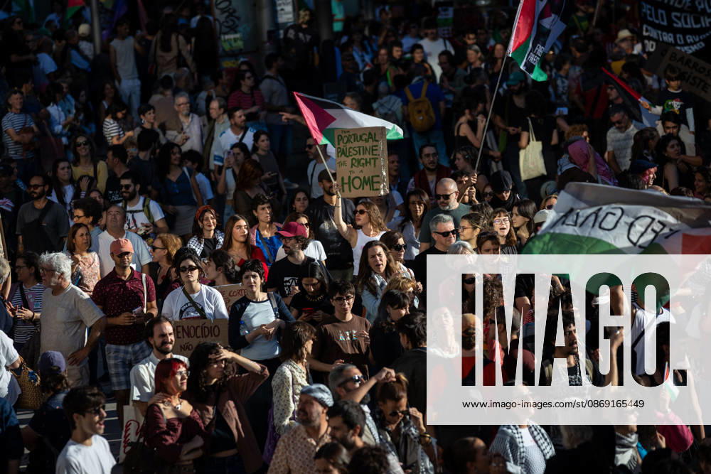 Palestine Solidarity March in Porto - 10 Oct 2026 Participants with Palestinian flags and placards gather at Praça D. João I at the end of a Palestine solidarity march. Hundreds of demonstrators gathered in Porto for a Palestine solidarity march calling for an end to the war in Gaza and support for Palestinian rights. The march began at Praça dos Poveiros and concluded at Praça D. João I. Porto Portugal