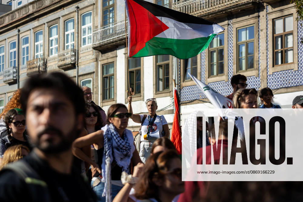 Participants hold Palestinian flags during a global day of action for Palestine. Hundreds of demonstrators gathered in Porto for a Palestine solidarity march calling for an end to the war in Gaza and support for Palestinian rights. The march began at Praca dos Poveiros and concluded at Praca D. Joao I. Porto Portugal - ZUMAs197 20261010_aaa_s197_448