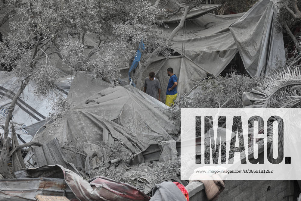Israeli attack on Az-Zawayda area in Gaza DEIR AL-BALAH, GAZA, PALESTINE - OCTOBER 11: People stand near damaged tents and makeshift shelters following an Israeli airstrike targeting a building belonging to the Buheysi family in the town of Az-Zawayda, near Deir al-Balah in the central Gaza Strip, on October 11, 2026. Israeli forces carried out the strike despite the ceasefire, destroying the targeted building and damaging surrounding structures. Adam Bilal Anadolu Deir Al-Balah Gaza. Editorial use only. Please get in touch for any other usage.