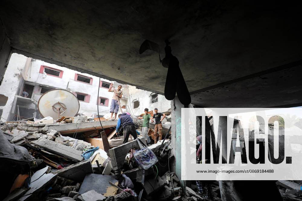 Palestinians Inspect Damage After Strike in Al-Zawayda Palestinians inspect their belongings amid the rubble of damaged residential buildings after an Israeli airstrike targeted a residential block in Al-Zawayda, in the central Gaza Strip, on October 11, 2026. Photo by Moiz Salhi apaimages Nusairat Gaza Strip Palestinian Territory 111026_Al-Zawayda_MS_00(35)