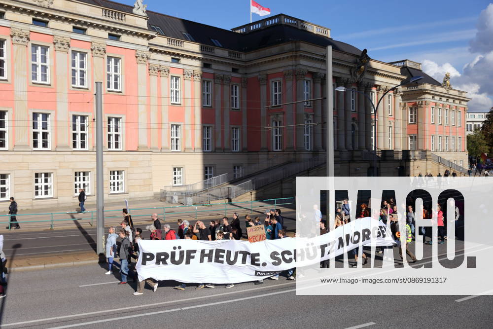 Demonstranten laufen mit Banner Prüf heute. Schütz morgen! am Landtag während einer Demonstration für die Überprüfung rechtsextremer Parteien durch das Bundesverfassungsgericht, Potsdam, 10. Oktober 2026. Prüf-Demo in Potsdam