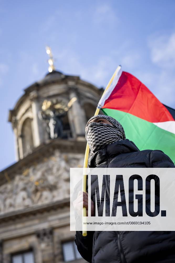 AMSTERDAM - A demonstrator during a national protest on Dam Square marking the conclusion of the nationwide week of action for sanctions against Israel. According to various activist groups, despite the ceasefire , the genocide against the Palestinian people continues unabated. KOEN VAN WEEL ANP netherlands out - belgium out