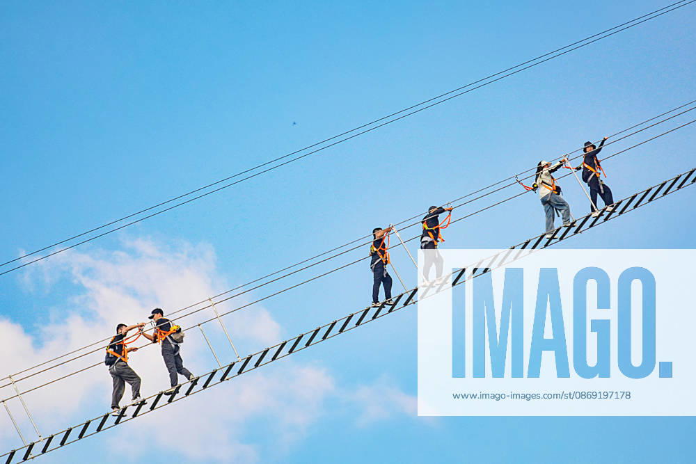 China Sky Ladder Challenger Tourists climb up a 250-meter-long soft ladder between two mountains in Mingtangshan Scenic Area in Yuexi county in central China s Anhui province, Sunday, Oct. 11, 2026. The rope ladder has 620 steps and a vertical distance of 365 meters. It opened to tourists in June this year, and quickly became a tourist attraction., Credit:stringer Utuku Feature China Avalon CHINA, ANHUI, YUEXI