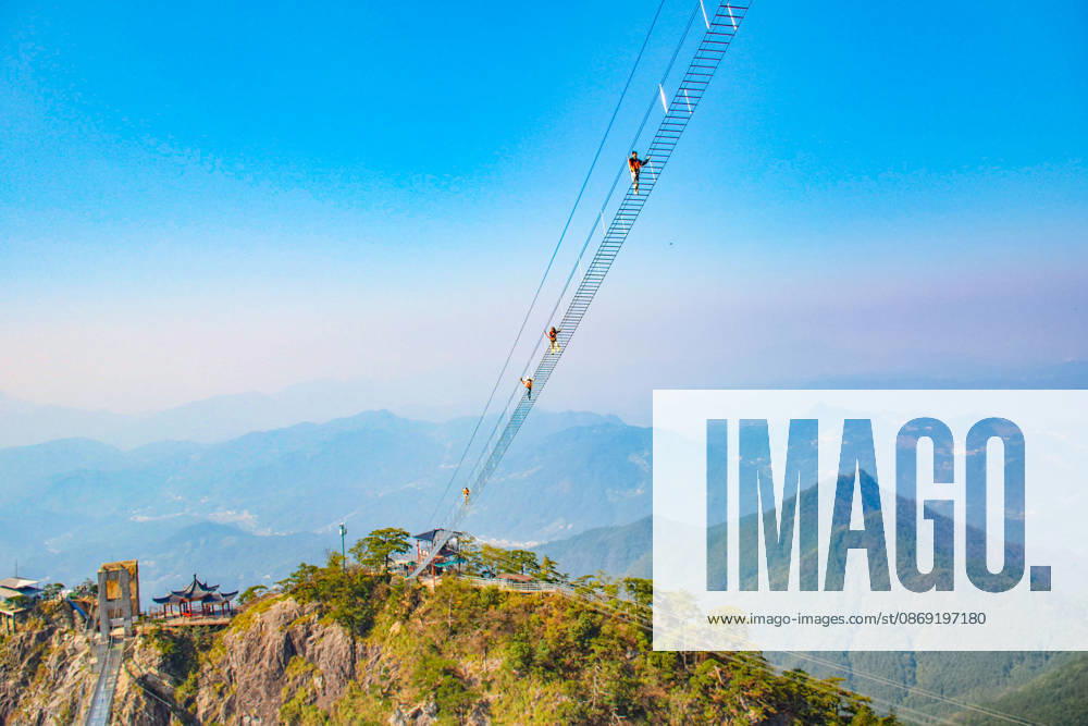 China Sky Ladder Challenger Tourists climb up a 250-meter-long soft ladder between two mountains in Mingtangshan Scenic Area in Yuexi county in central China s Anhui province, Sunday, Oct. 11, 2026. The rope ladder has 620 steps and a vertical distance of 365 meters. It opened to tourists in June this year, and quickly became a tourist attraction., Credit:stringer Utuku Feature China Avalon CHINA, ANHUI, YUEXI
