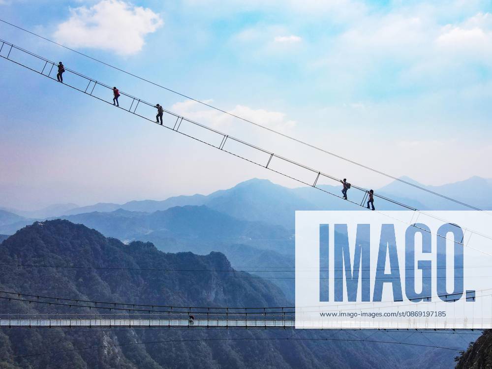 China Sky Ladder Challenger Tourists climb up a 250-meter-long soft ladder between two mountains in Mingtangshan Scenic Area in Yuexi county in central China s Anhui province, Sunday, Oct. 11, 2026. The rope ladder has 620 steps and a vertical distance of 365 meters. It opened to tourists in June this year, and quickly became a tourist attraction., Credit:stringer Utuku Feature China Avalon CHINA, ANHUI, YUEXI