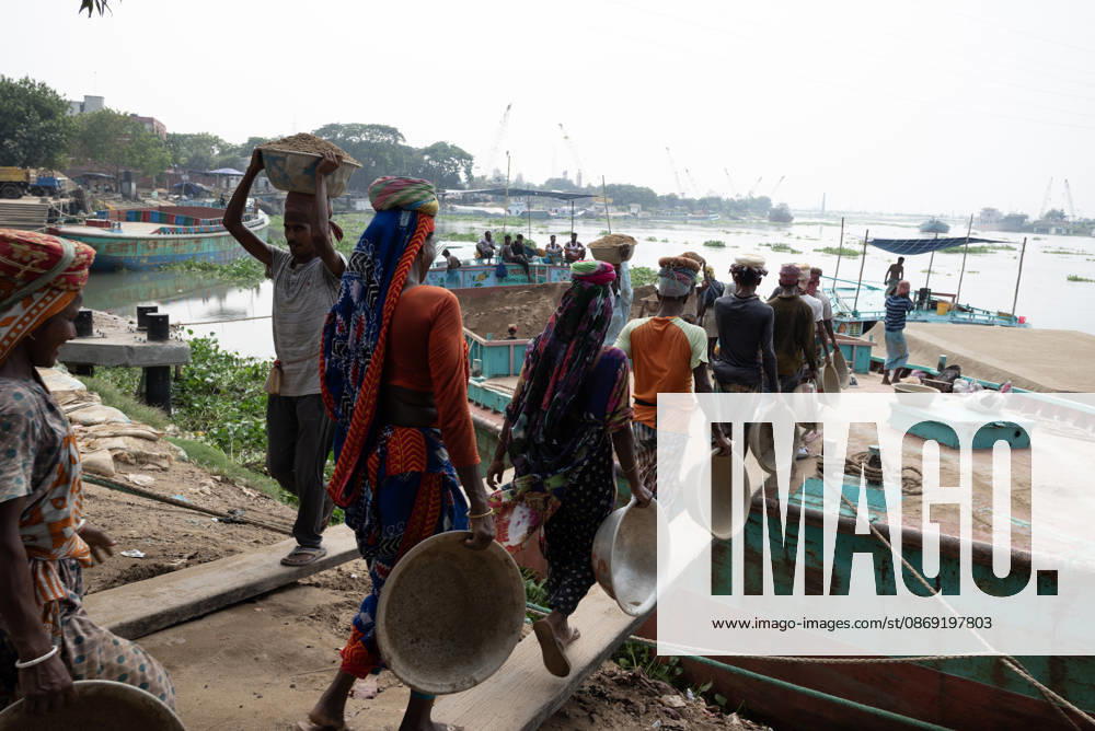Migrant Workers Unload Sand Workers unload sand at a riverside site in Gabtoli, Dhaka, Bangladesh, on October 11, 2026. Many have left rural communities in search of employment in the capital, where daily labor provides a source of income but often involves strenuous work and limited financial security. Dhaka Bangladesh