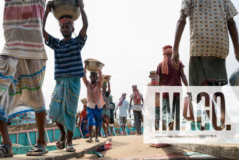 Migrant Workers Unload Sand Workers unload sand at a riverside site in Gabtoli, Dhaka, Bangladesh, on October 11, 2026. Many have left rural communities in search of employment in the capital, where daily labor provides a source of income but often involves strenuous work and limited financial security. Dhaka Bangladesh